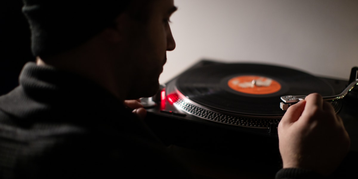 Man playing music on record player